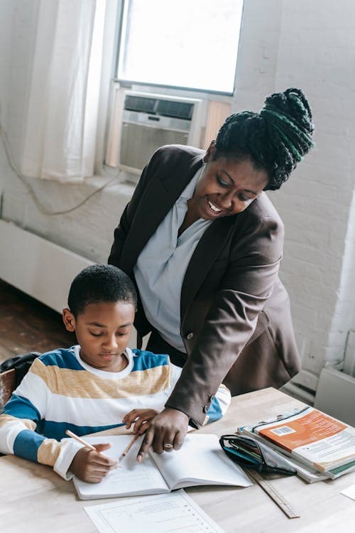 A tutor helping a student with their studies
